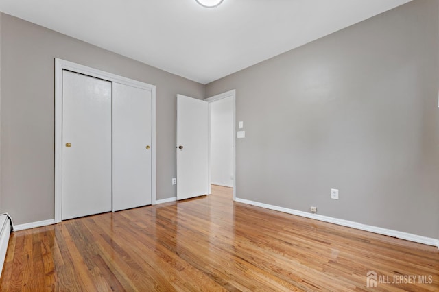 40 Montclair Ave, Edison, NJ 08820 - unfurnished bedroom featuring wood finished floors, baseboards, and a baseboard heating unit