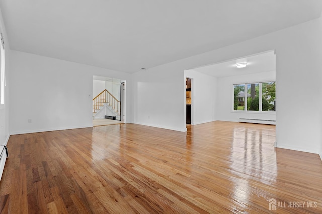 40 Montclair Ave, Edison, NJ 08820 - unfurnished living room with a baseboard radiator, stairs, light wood finished floors, and baseboards