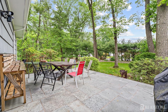 40 Montclair Ave, Edison, NJ 08820 - view of patio featuring outdoor dining space and view of wooded area