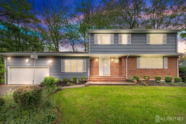 40 Montclair Ave, Edison, NJ 08820 - colonial-style house with a garage, driveway, a yard, and brick siding