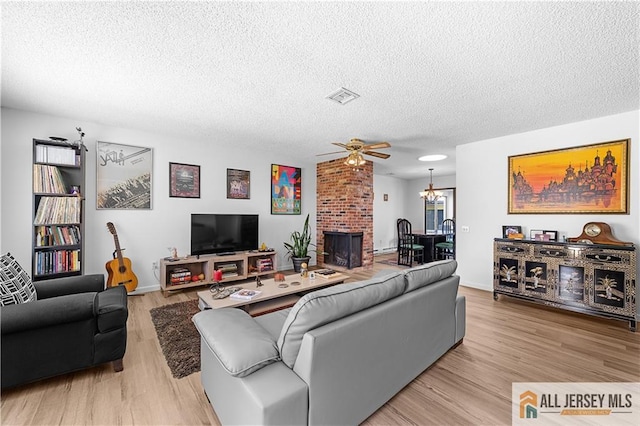 21 Celtis Plz Unit 21B, Monroe, NJ 08831 - living room with a textured ceiling, ceiling fan, and light wood-style flooring