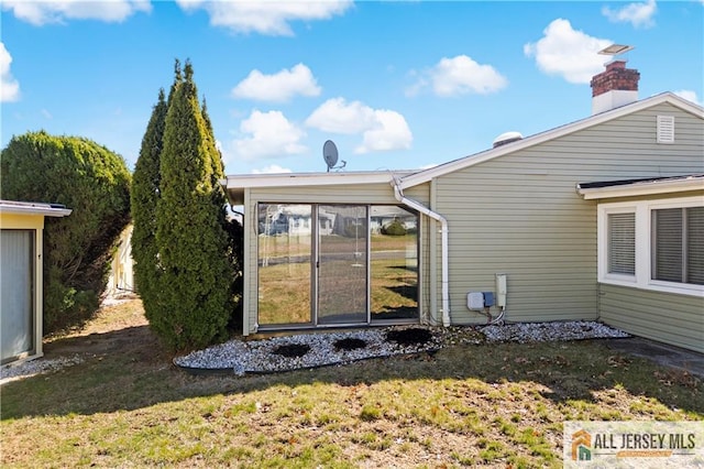 21 Celtis Plz Unit 21B, Monroe, NJ 08831 - back of property featuring a chimney, a lawn, and a sunroom