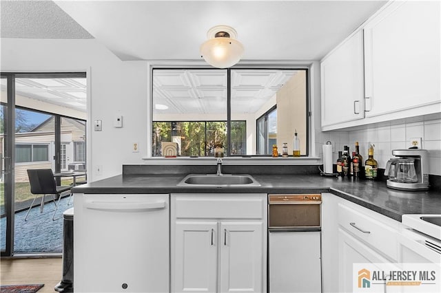 21 Celtis Plz Unit 21B, Monroe, NJ 08831 - kitchen featuring white dishwasher, a sink, plenty of natural light, and dark countertops