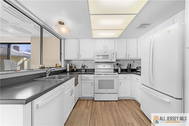 21 Celtis Plz Unit 21B, Monroe, NJ 08831 - kitchen featuring white appliances, a sink, dark countertops, and white cabinets