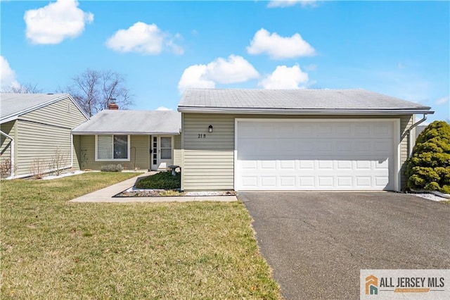21 Celtis Plz Unit 21B, Monroe, NJ 08831 - view of front of home with driveway, a front yard, a garage, and a chimney