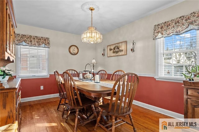 dining area featuring a wealth of natural light, baseboards, and wood finished floors