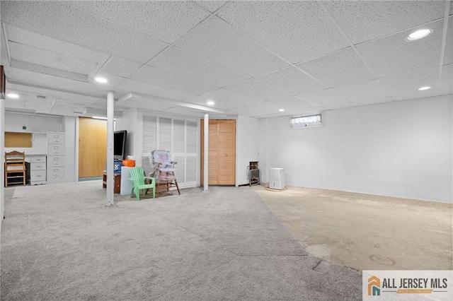 basement featuring recessed lighting and a paneled ceiling