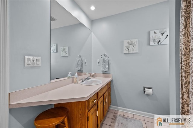 full bath with tile patterned flooring, vanity, visible vents, and baseboards