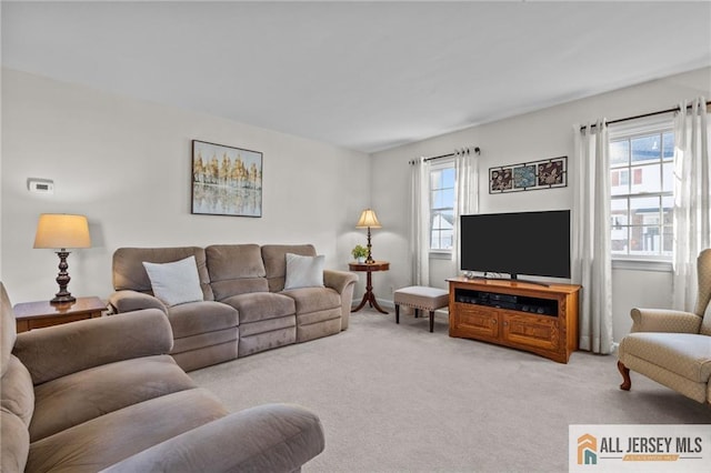 living room with plenty of natural light and light carpet