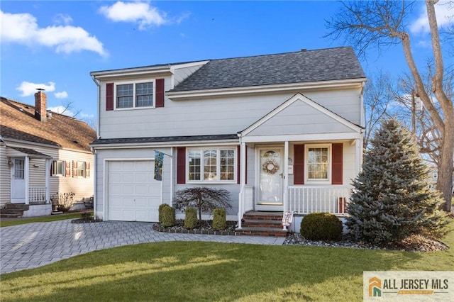 view of front of property featuring a front yard, roof with shingles, covered porch, decorative driveway, and an attached garage