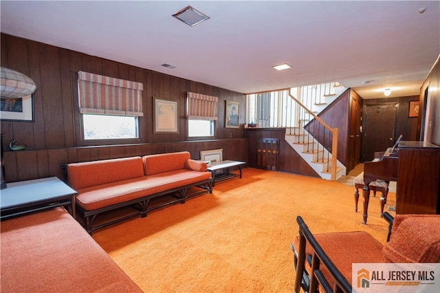 12 Tompkins Rd, East Brunswick, NJ 08816 - living room featuring stairs, carpet floors, and wood walls