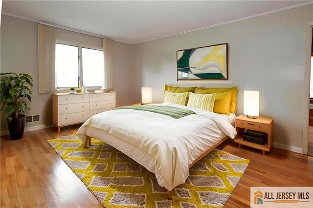 12 Tompkins Rd, East Brunswick, NJ 08816 - bedroom with crown molding and light wood-type flooring