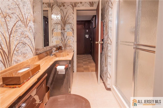 12 Tompkins Rd, East Brunswick, NJ 08816 - bathroom with wallpapered walls, a stall shower, double vanity, and tile patterned flooring