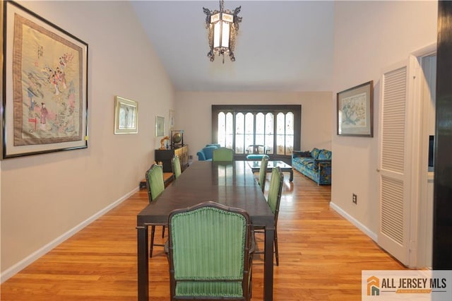 12 Tompkins Rd, East Brunswick, NJ 08816 - dining area featuring a chandelier, light wood-style flooring, and high vaulted ceiling
