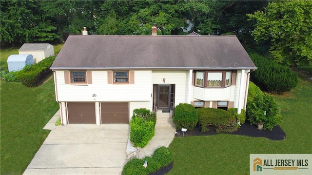 12 Tompkins Rd, East Brunswick, NJ 08816 - bi-level home with a garage, a front yard, driveway, and a chimney