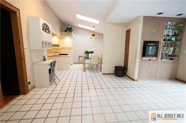 12 Tompkins Rd, East Brunswick, NJ 08816 - kitchen featuring lofted ceiling, a skylight, light countertops, light tile patterned flooring, and pendant lighting