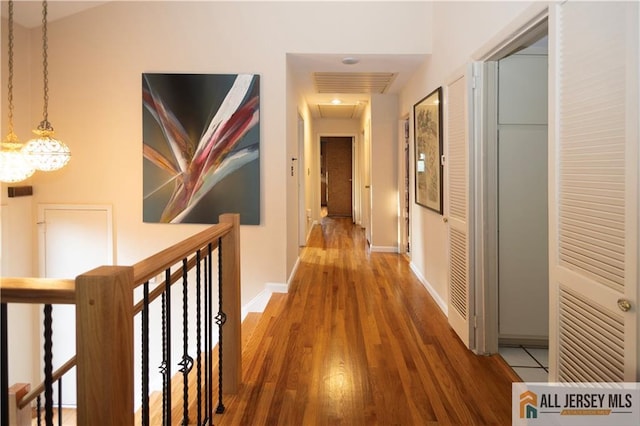 12 Tompkins Rd, East Brunswick, NJ 08816 - hall featuring wood finished floors, an upstairs landing, and a chandelier