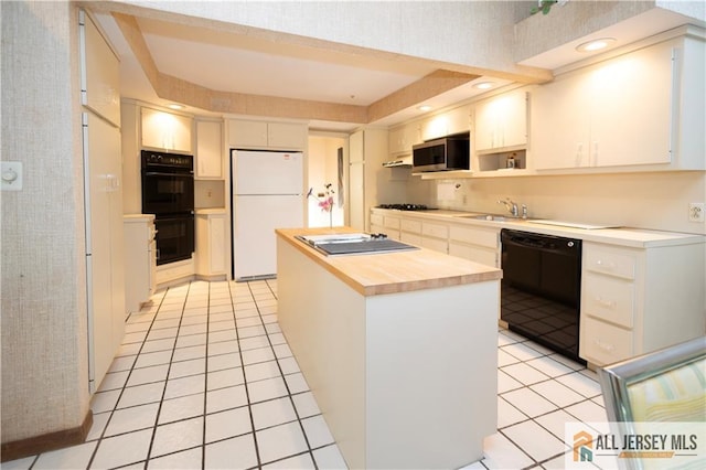 12 Tompkins Rd, East Brunswick, NJ 08816 - kitchen with black appliances, light tile patterned floors, wood counters, a center island, and white cabinetry