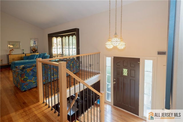 12 Tompkins Rd, East Brunswick, NJ 08816 - entrance foyer featuring a chandelier, wood finished floors, plenty of natural light, and high vaulted ceiling