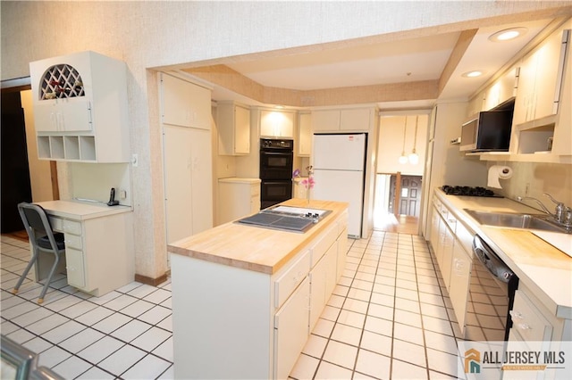 12 Tompkins Rd, East Brunswick, NJ 08816 - kitchen with black appliances, light tile patterned floors, a center island, open shelves, and wooden counters