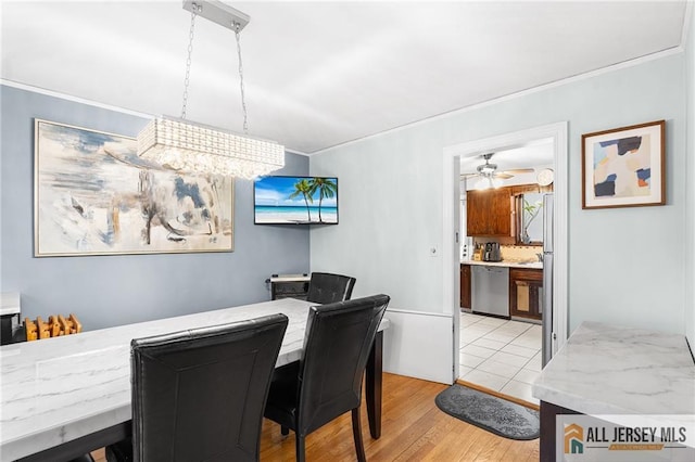 58 Stewart Pl S, Orange Village, NJ 07079 - dining area with crown molding, light wood finished floors, and a ceiling fan