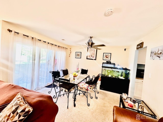 dining area featuring light colored carpet and ceiling fan