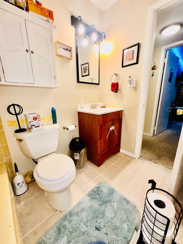 bathroom featuring vanity, toilet, and tile patterned flooring