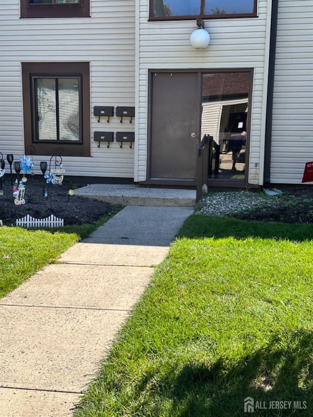 entrance to property featuring a yard