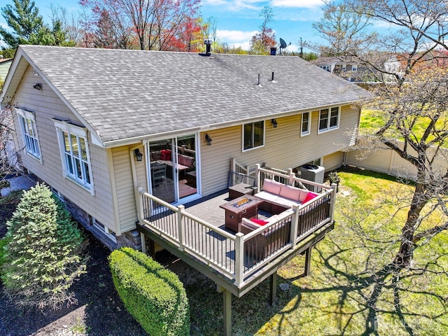 7 Arthurs Ct, Manalapan, NJ 07726 - back of property with roof with shingles, a deck, central AC unit, and an outdoor living space with a fire pit