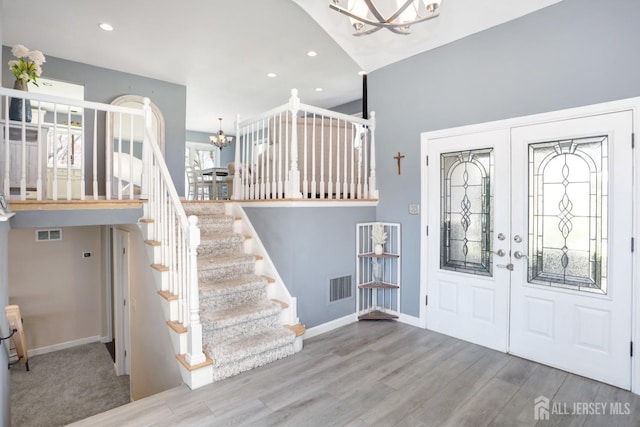 7 Arthurs Ct, Manalapan, NJ 07726 - entryway featuring a chandelier, french doors, stairs, wood finished floors, and baseboards