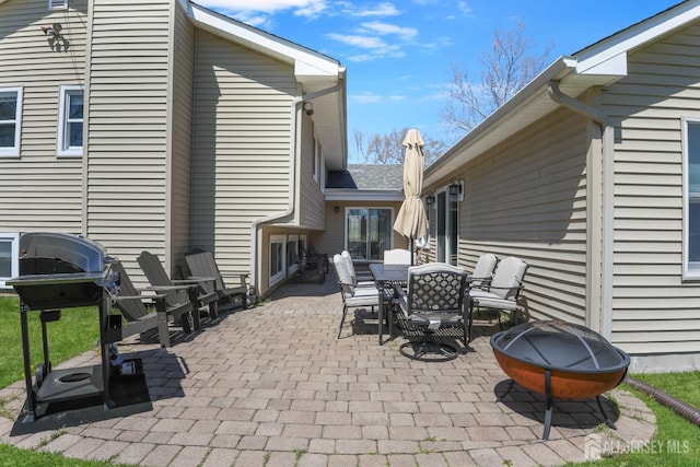 7 Arthurs Ct, Manalapan, NJ 07726 - view of patio featuring a fire pit, outdoor dining area, and a grill