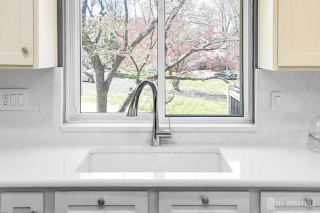 7 Arthurs Ct, Manalapan, NJ 07726 - kitchen view of a sink, light countertops, white cabinets, and backsplash