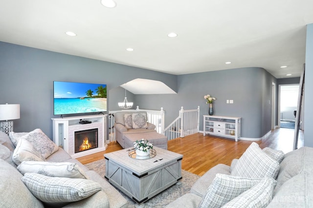 7 Arthurs Ct, Manalapan, NJ 07726 - living area featuring light wood-style floors, recessed lighting, and a warm lit fireplace