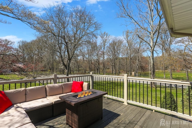 7 Arthurs Ct, Manalapan, NJ 07726 - deck featuring an outdoor living space with a fire pit, a lawn, and view of wooded area