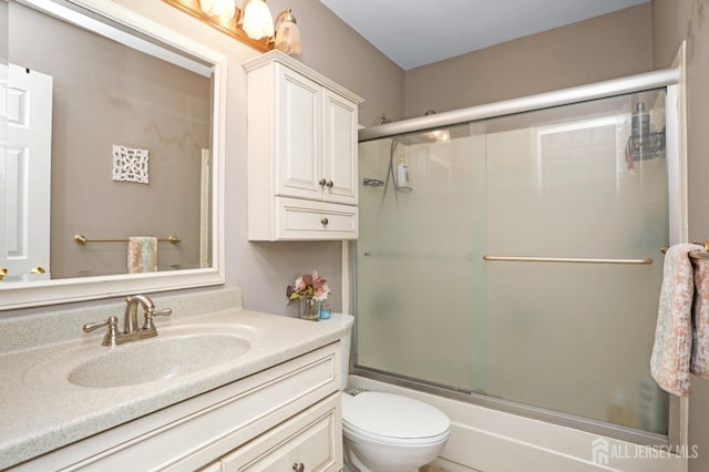 7 Arthurs Ct, Manalapan, NJ 07726 - bathroom with bath / shower combo with glass door, vanity, and toilet