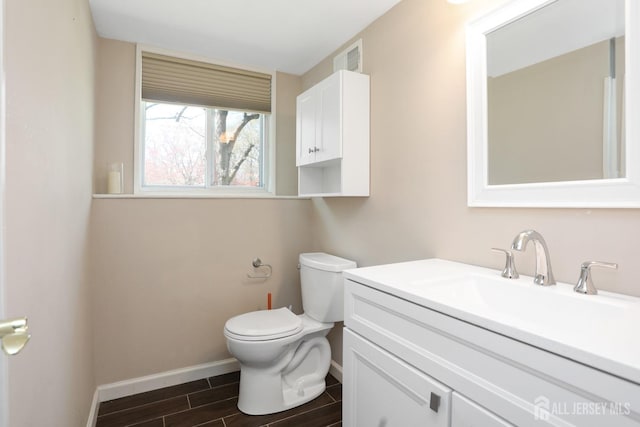 7 Arthurs Ct, Manalapan, NJ 07726 - half bathroom featuring toilet, wood tiled floors, baseboards, and vanity