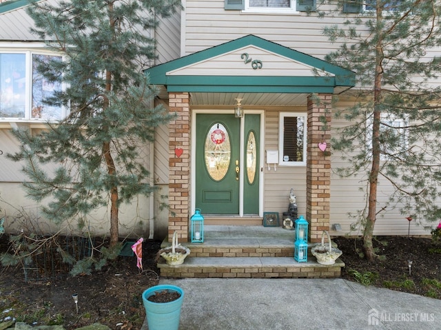 property entrance featuring brick siding