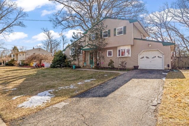 view of front of home featuring a garage and a front lawn