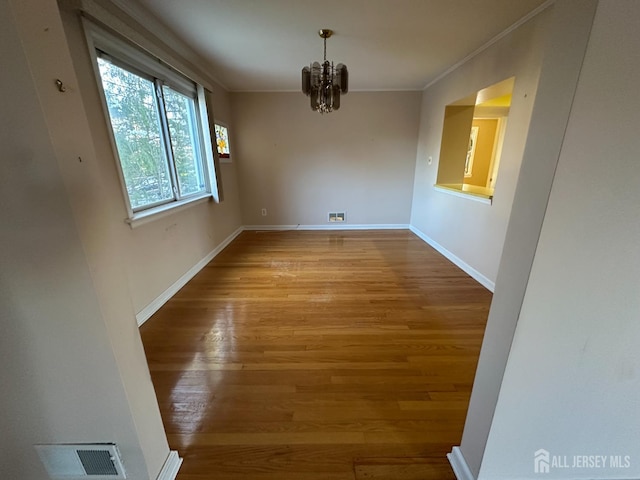 29 Glendale Rd, Colonia, NJ 07067 - unfurnished dining area featuring wood finished floors, a chandelier, ornamental molding, and baseboards