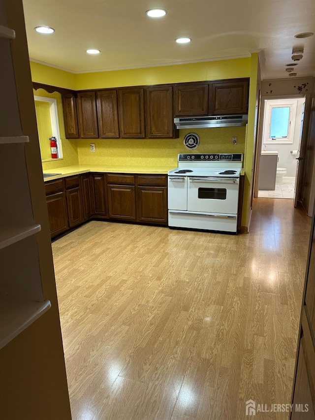 29 Glendale Rd, Colonia, NJ 07067 - kitchen with white electric range, light countertops, exhaust hood, light wood-type flooring, and recessed lighting