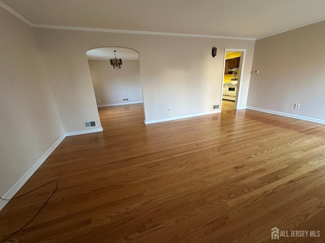 29 Glendale Rd, Colonia, NJ 07067 - unfurnished room with baseboards, light wood-style flooring, ornamental molding, and a chandelier