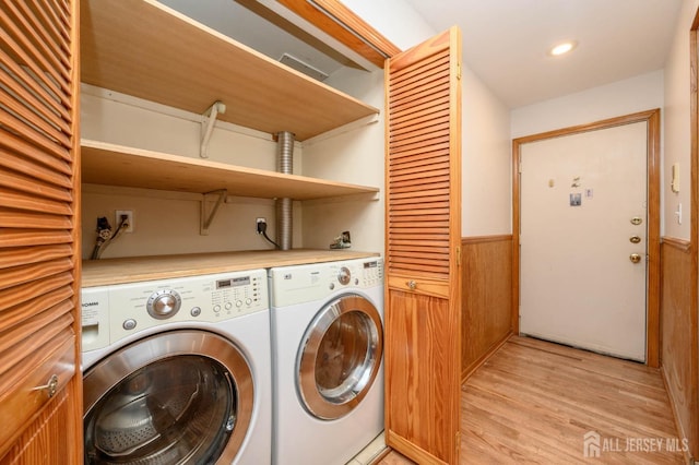 washroom with visible vents, light wood finished floors, laundry area, wainscoting, and independent washer and dryer