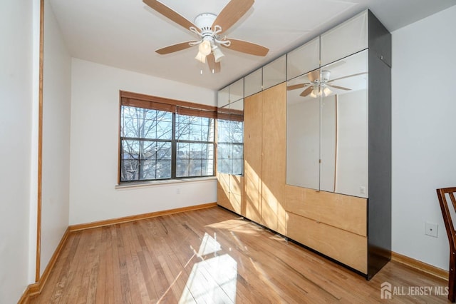 unfurnished bedroom featuring light hardwood / wood-style flooring and ceiling fan