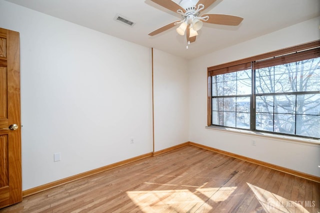 spare room featuring ceiling fan and light hardwood / wood-style flooring