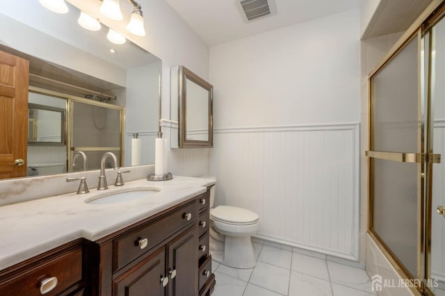 full bath with visible vents, wainscoting, toilet, and vanity