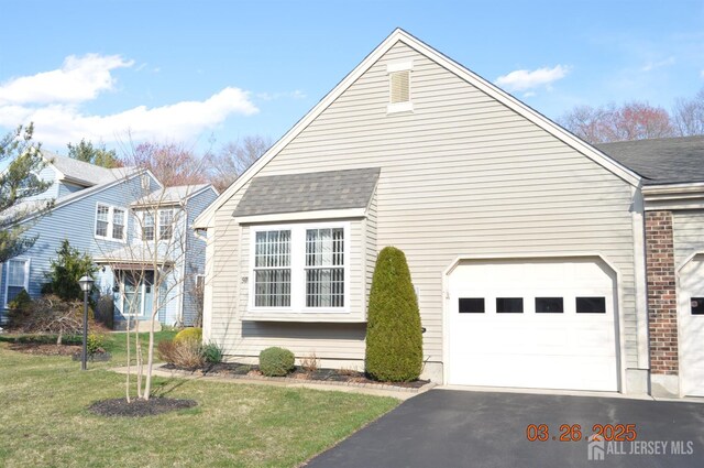 9-B Melborn Dr Unit 9B, Monroe, NJ 08831 - view of home's exterior with asphalt driveway, roof with shingles, a lawn, and a garage