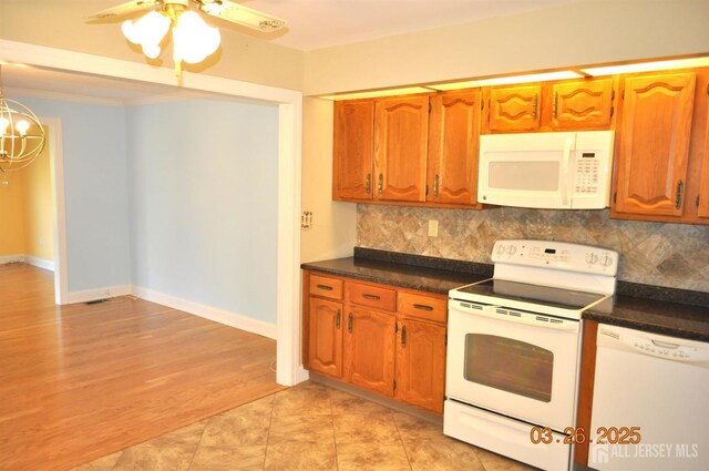 9-B Melborn Dr Unit 9B, Monroe, NJ 08831 - kitchen featuring white appliances, dark countertops, tasteful backsplash, brown cabinetry, and ceiling fan
