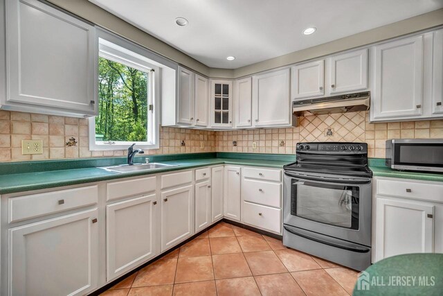 15 Federal Rd, Monroe, NJ 08831 - kitchen featuring appliances with stainless steel finishes, under cabinet range hood, a sink, light tile patterned flooring, and white cabinets