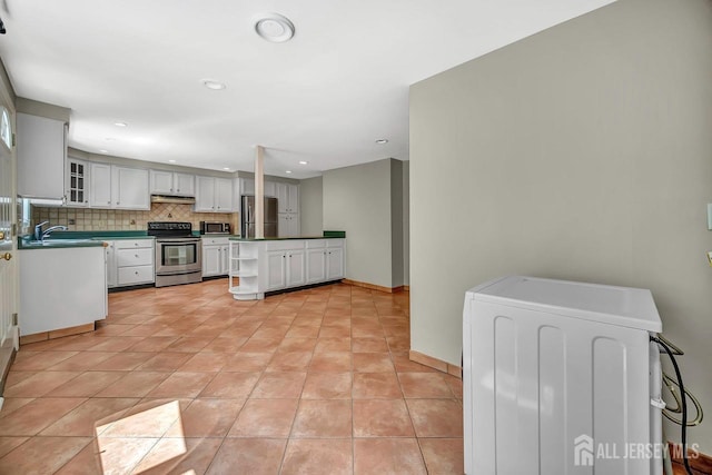 15 Federal Rd, Monroe, NJ 08831 - kitchen featuring appliances with stainless steel finishes, under cabinet range hood, tasteful backsplash, a sink, and glass insert cabinets