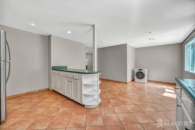 15 Federal Rd, Monroe, NJ 08831 - kitchen with freestanding refrigerator, open shelves, washer / clothes dryer, dark countertops, and plenty of natural light